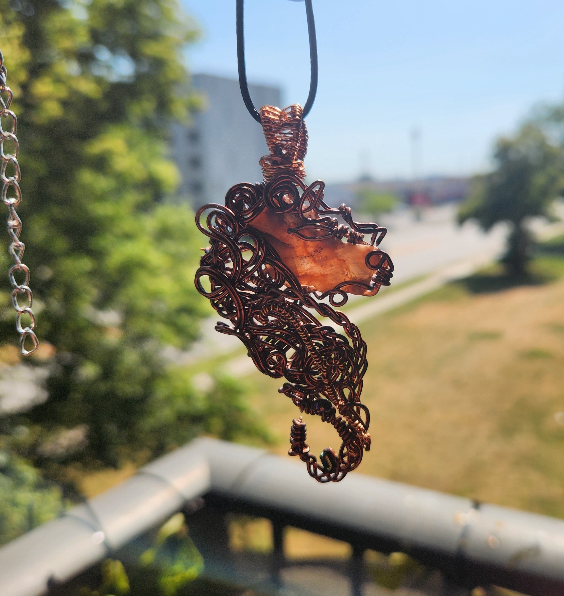Whispers Through the Veil - Handwoven copper wire pendant featuring a raw druzy quartz focal stone with intricate sculptural detailing and subtle bead accents. This one-of-a-kind wearable art piece was created freeform — no molds, no pattern, no duplication. The flowing copper weaves organically around the stone, creating movement, depth, and texture from every angle. • Solid copper wire (sealed for longevity) • Raw druzy quartz focal • One of a kind — never replicated • Comes ready to gift A statement piece for lovers of earthy elegance, artisan craftsmanship, and soulful adornment.
