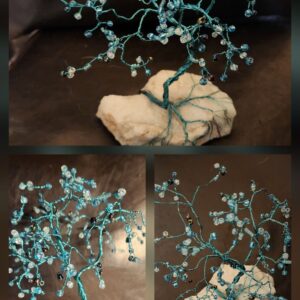 This hand-twisted wire tree is adorned with shimmering glass beads and rooted on a natural milky quartz base. Its flowing branches and cool blue tones were inspired by the calm, cleansing energy of water. A beautiful little reminder to breathe, soften, and let your spirit flow.